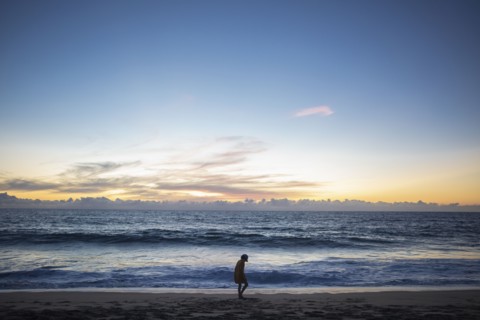 Mexico, Baja, Pescadero, Silhouette of boy on beach at dusk, Pescadero, Baja, Mexcio