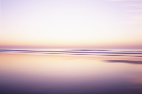 USA, New Jersey, Stone Harbor, Calm purple and orange water surface and sky at sunrise, Stone