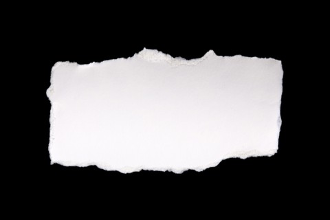 Torn peace of paper on black background, New York City, New York, USA
