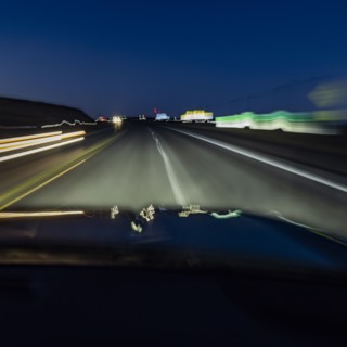 Highway at night seen from moving vehicle, blurred motion, Twin Falls, Idaho, USA