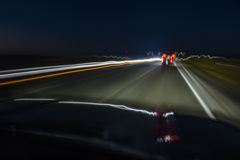 Highway at night seen from moving vehicle, blurred motion, Twin Falls, Idaho, USA