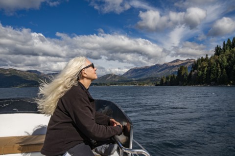 Woman with long white hair on boat on Lake Nahuel Huapi, Bariloche, Rio Negro, Argentina