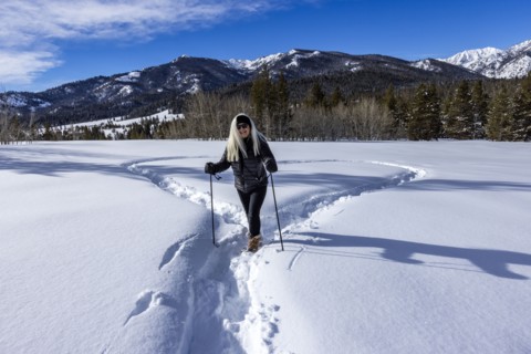 Smiling woman snowshoeing in winter landscape, Sun Valley, Idaho, USA