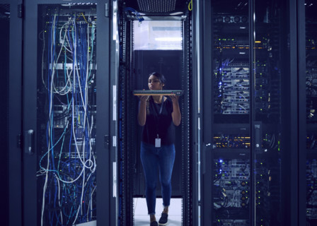 Female technician holding hard drive in server room
St, George, Utah, USA