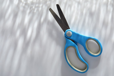 Blue children's scissors on white background
New York City, New York State, USA