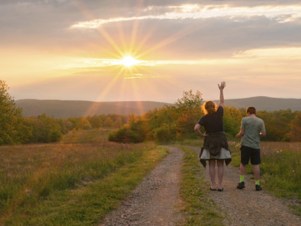 Rear view of mother and son (16-17) standing on dirt road in landscape at sunset
Blacksburg,