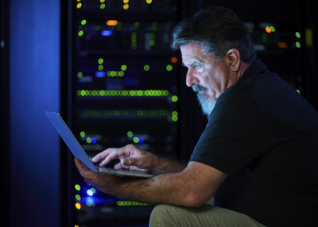 Man using laptop in data center