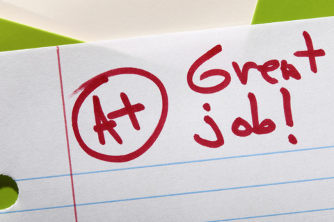 Close-up of A+ grade on lined paper