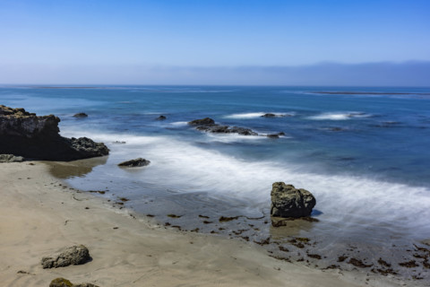 USA, California, San Simeon, Ocean waves washing sandy beach, long exposure