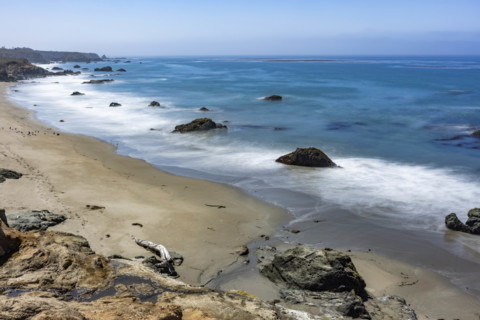 USA, California, San Simeon, Ocean waves washing sandy beach, long exposure