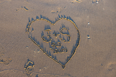 Heart with message in sand
