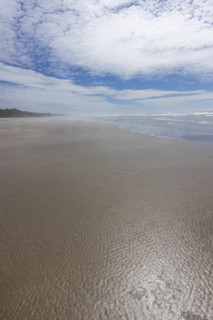 USA, Oregon, Newport, White puffy clouds above empty beach