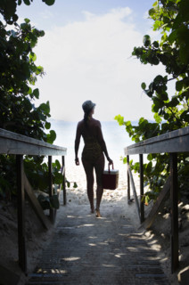 USA, United States Virgin Islands, St. John, Woman on path to tropical beach