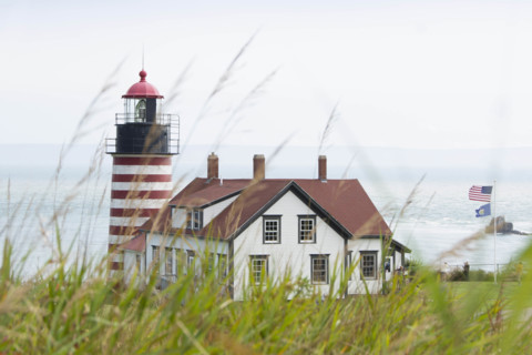 USA, Maine, Lubec, West Quoddy Head Lighthouse with grass in foreground