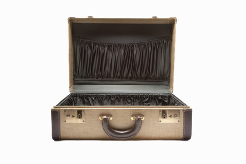 Open antique suitcase on white background