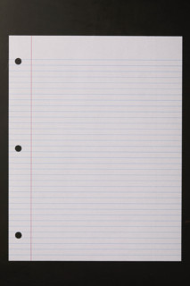 Blank lined paper on black background