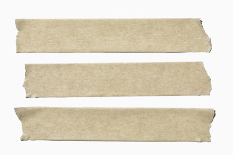 Three straps of masking tape on white background