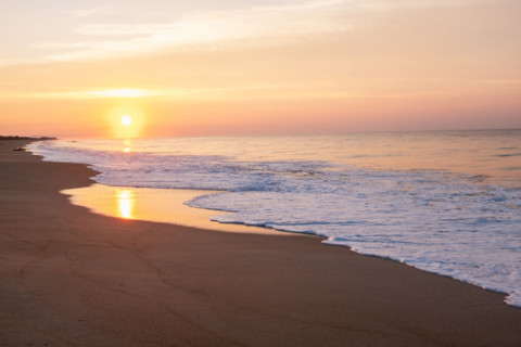 Mexico, Oaxaca State, Puerto Escondido, Costa Chica, Sun setting over ocean and empty beach