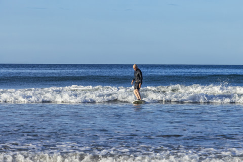 Costa Rica, Guanacaste, Playa Grande, Senior man surfing on sea wave