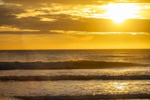 Costa Rica, Guanacaste, Playa Grande, Sun setting over calm sea