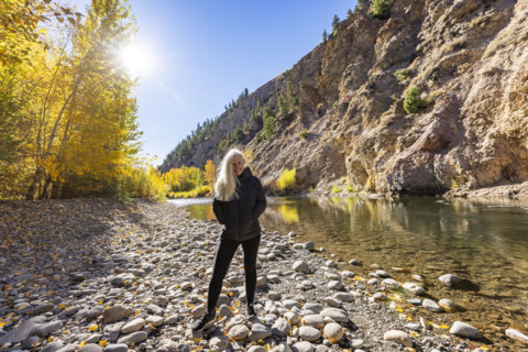 USA, Idaho, Bellevue, Portrait of senior blonde woman at river in autumn