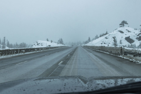 USA, California, Donner Pass, Empty highway seen from car during rain in winter