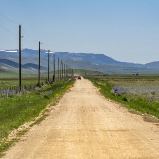 Empty dirt road crossing Camas Prairie. Fairfield, Idaho, USA.