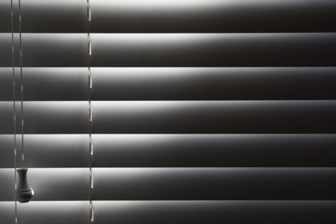 Close-up of window blinds with sunlight. New York City, New York State, USA.