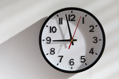 Wall clock with sunlight and shadow Background. New York City, New York State, USA.