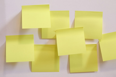 Blank yellow post it notes on wall. New York City, New York State, USA.