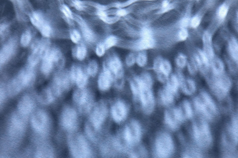 Dappled light on blue background. New York City, New York State, USA.