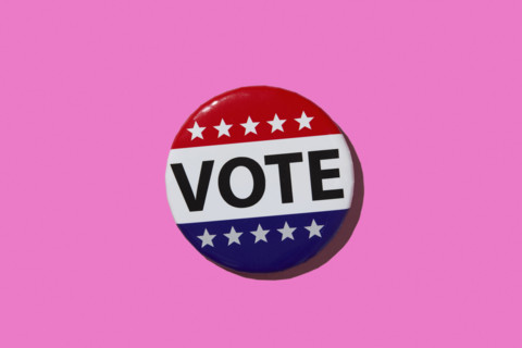 Vote pin on pink background. New York City, New York State, USA.