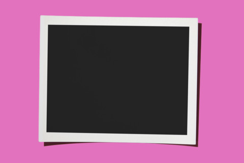 Blank Polaroid on pink background. New York City, New York State, USA.