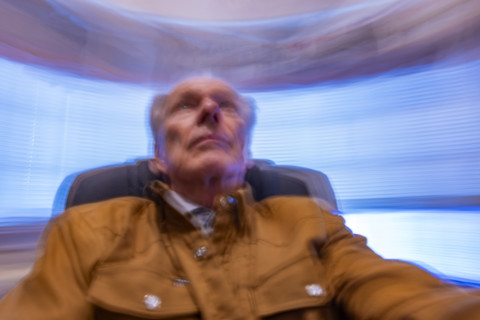 Senior man in desk chair, motion blurred. Bellevue, Idaho, USA.