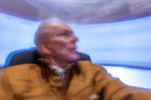 Senior man in desk chair, motion blurred. Bellevue, Idaho, USA.