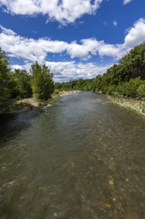 White puffy clouds above Big Wood River . Bellevue, Idaho, USA.