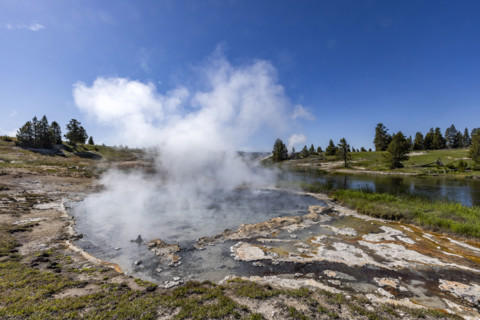 Hot spring emitting steam near Firehole River. , Wyoming, USA.