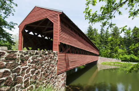 Haunted Sachs Covered Bridge over calm Marsh Creek. Adams, Pennsylvania, USA.