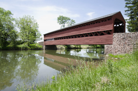 Haunted Sachs Covered Bridge over calm Marsh Creek. Adams, Pennsylvania, USA.