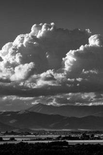 White puffy clouds over mountains, black and white. Bellevue, Idaho, USA.