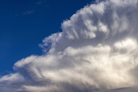 Dramatic white clouds in sunlight on blue sky. Bellevue, Idaho, USA.