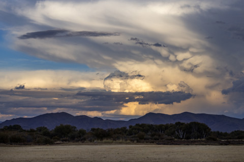 Dramatic clouds over mountains and field. Bellevue, Idaho, USA.