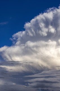 Dramatic white clouds in sunlight on blue sky. Bellevue, Idaho, USA.