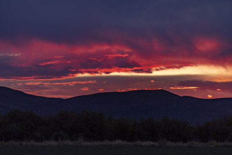 Dramatic clouds over mountains and field. Bellevue, Idaho, USA.