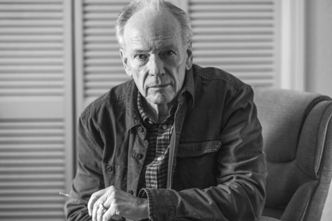 Portrait of senior man sitting in armchair, black and white. Boise, Idaho, USA.