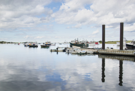 Pier and boats moored at harbor. Cape Cod, Massachusetts, USA.