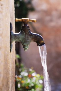 Close-up of water flowing from garden faucet. St. Paul de Vence, , France.