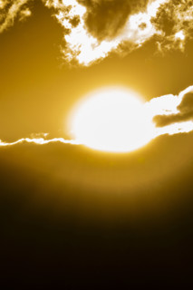 Golden sun setting behind clouds. Bellevue, Idaho, USA.