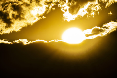 Golden sun setting behind clouds. Bellevue, Idaho, USA.