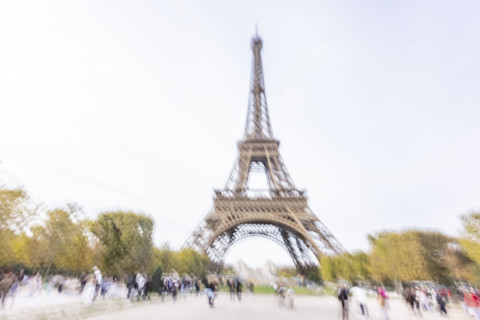 Tourists near Eiffel Tower, blurred motion. Paris, Ile de France, France.